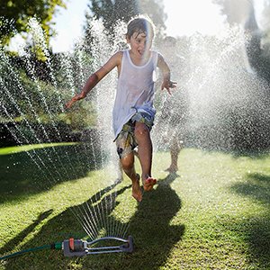 playing in sprinkler