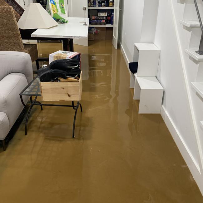 Basement flooded with sewage. The sewage is about ankle-deep and completely fills the basement level. Any furniture soaked in this will need professional deep-cleaning or professional disposal. 