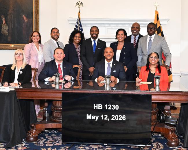 Governor Wes Moore signing House Bill 1230 at the State House with Lt Governor Aruna Miller along with WSSC Water Leadership including Monica Marquina, Kenneth Simons, Cristi Bickham, Kiyon Harley, GM & CEO Kishia Powell, and Terrence Stafford