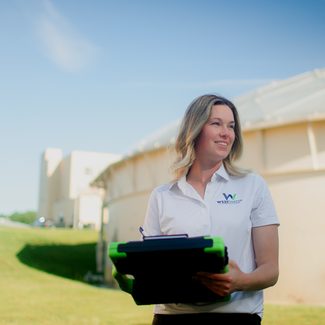 Gabriella Lafayette on an industrial discharge site with clipboard