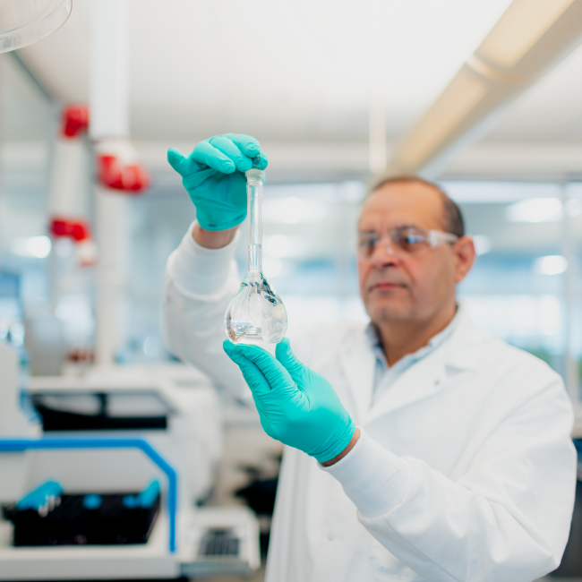 Ashraf Gawargeyous, senior chemist observing water in a beaker